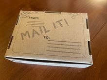 Load image into Gallery viewer, Brown craft box that the button comes in. This is the backside and has Mail It! Written on in along with places to write address and return address so it can be mailed directly in the packaging.